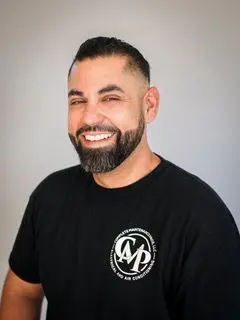 A man with a beard and mustache wearing a black shirt