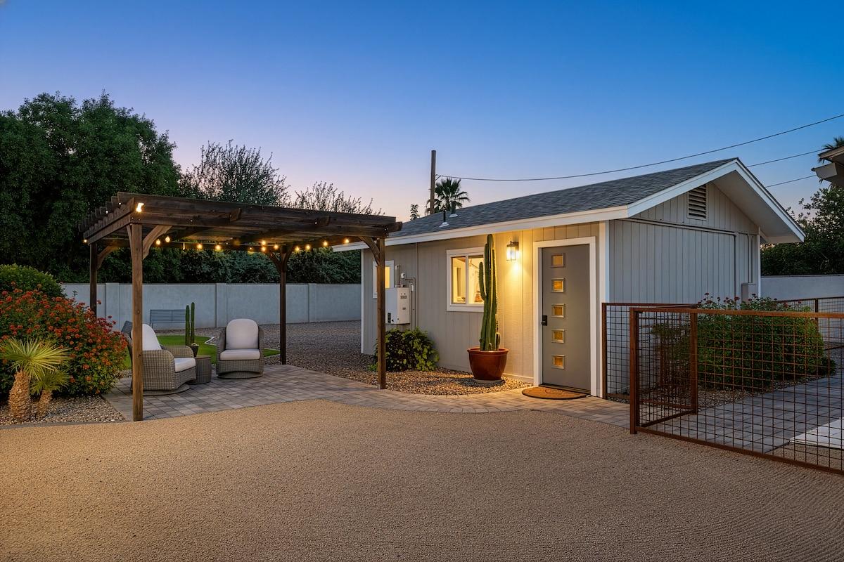 Backyard guesthouse with pergola and string lights