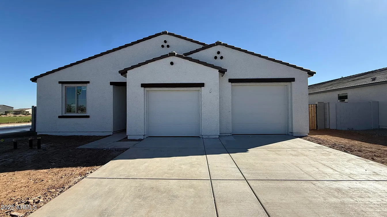 White stucco single-story home with double garage