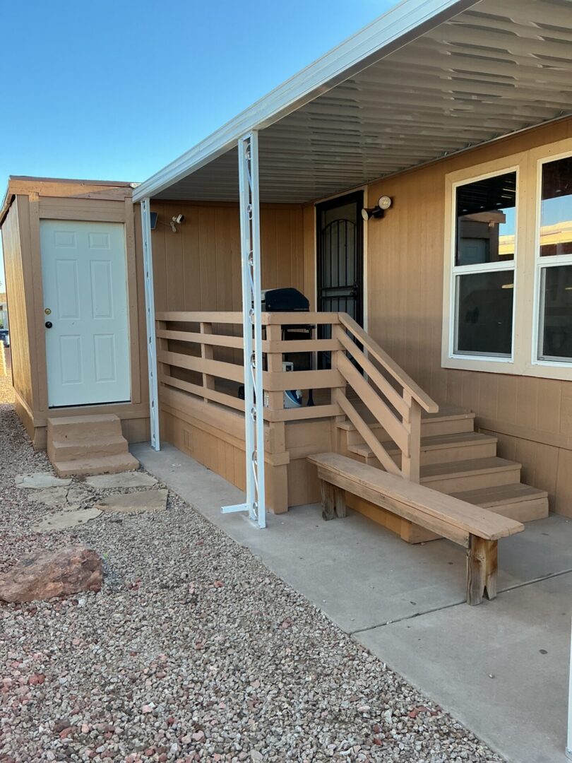 Covered porch with wooden steps and bench